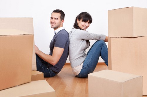 Packed moving boxes and furniture ready for collection in Cranford